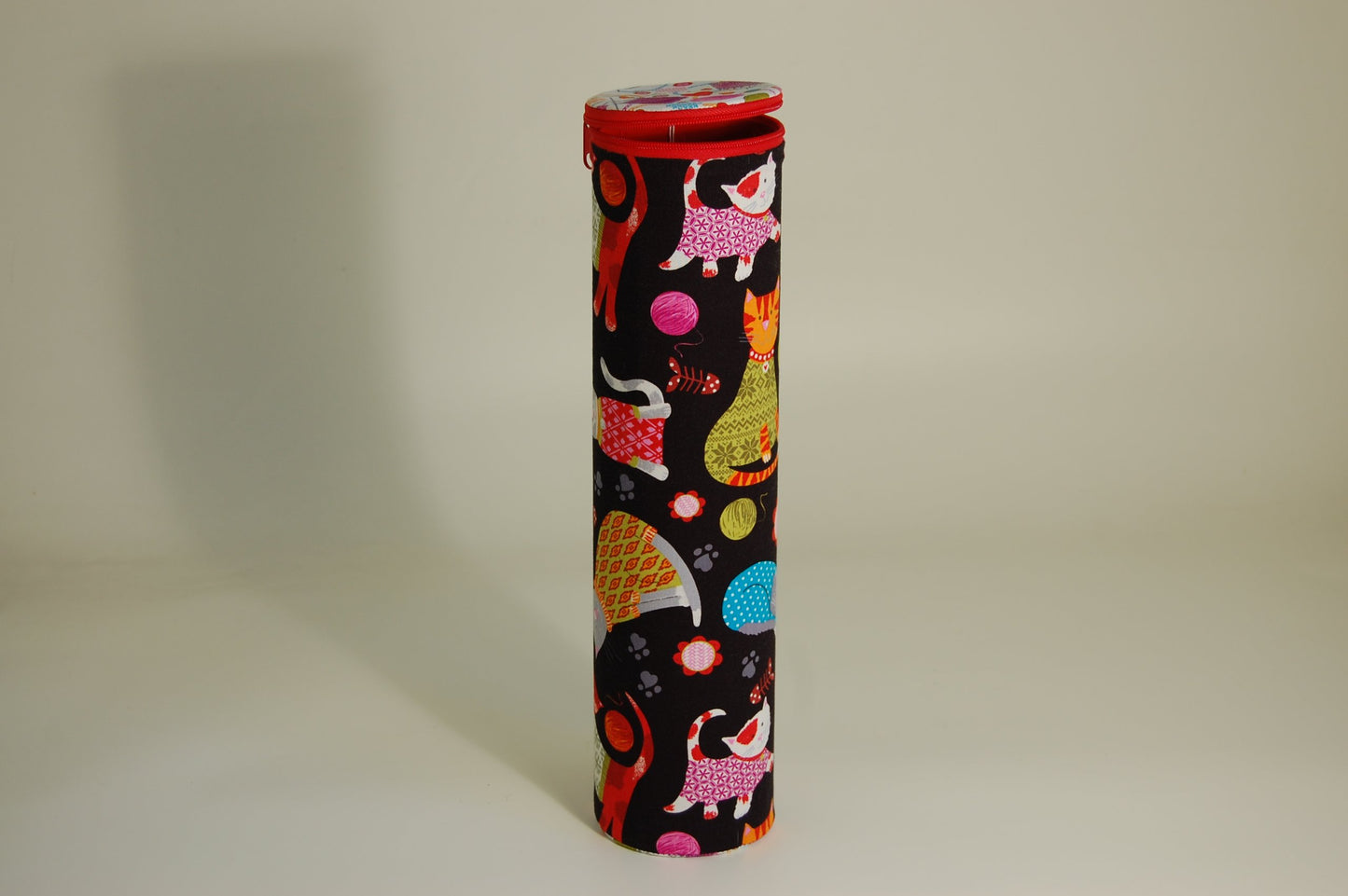 Knitting Pin holder - cylinder shape tube - fabric shows cartoon cats design on a dark background