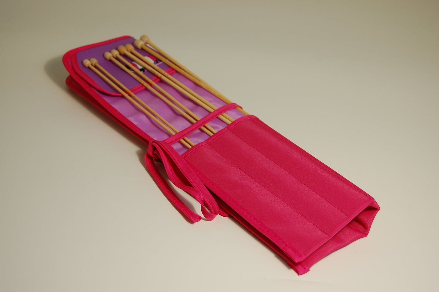 Knitting pins - 8 prs bamboo knitting needles in purple fabric case showing cartoon sheep