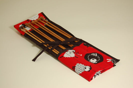 Knitting pins - 8 prs bamboo knitting needles in red fabric case showing black and white cartoon sheep - hanrattycraftsgifts.co.uk